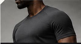 A close editorial crop of a gym-goer in a charcoal training tee
