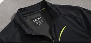A black training overshirt with a restrained lime detail